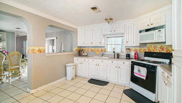 a kitchen with stainless steel appliances a stove a sink and a refrigerator