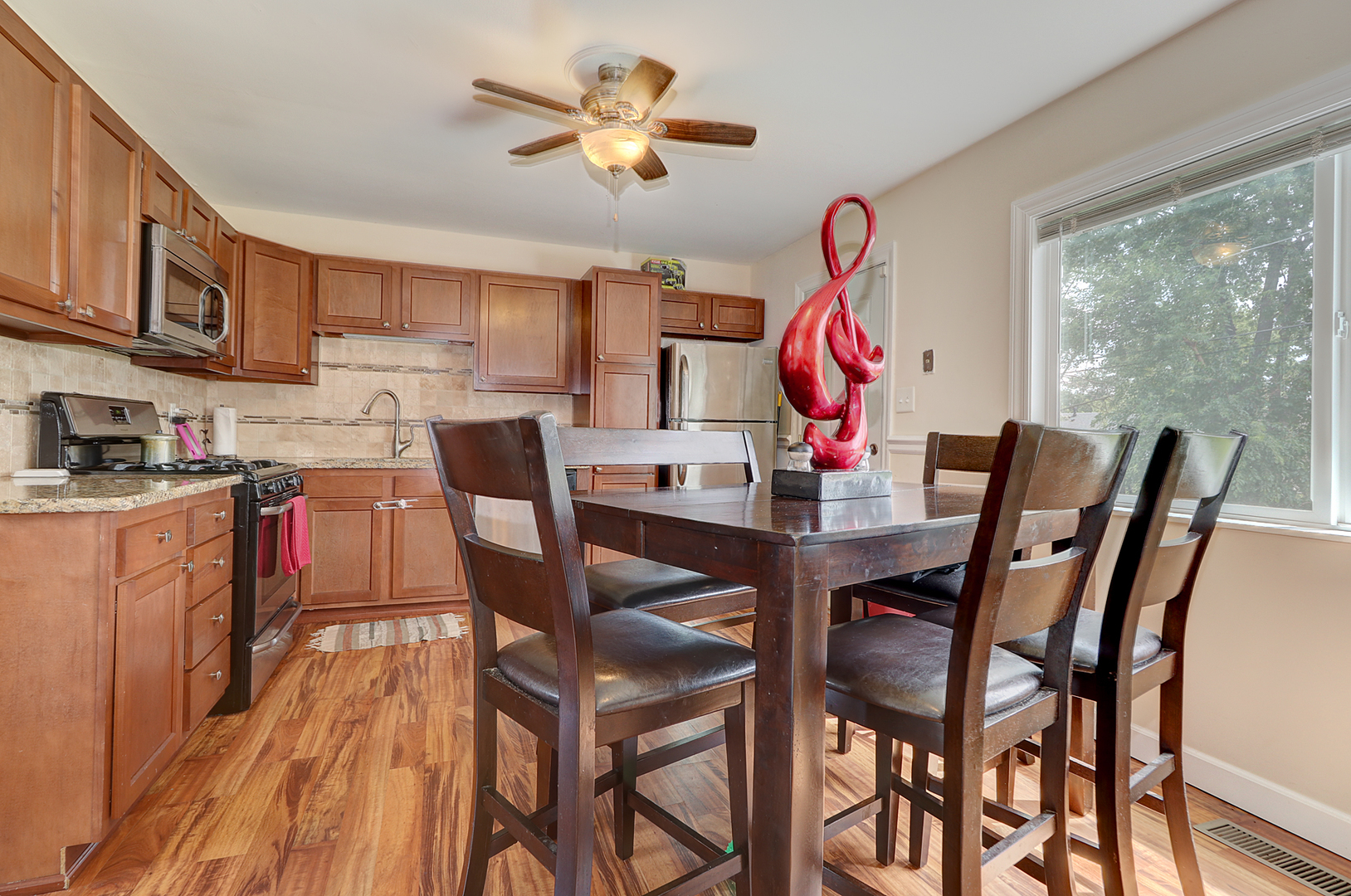 231 Murphy Drive Romeoville, IL 60446 - Photo 6 of 14 a view of a dining room with furniture wooden floor and a chandelier