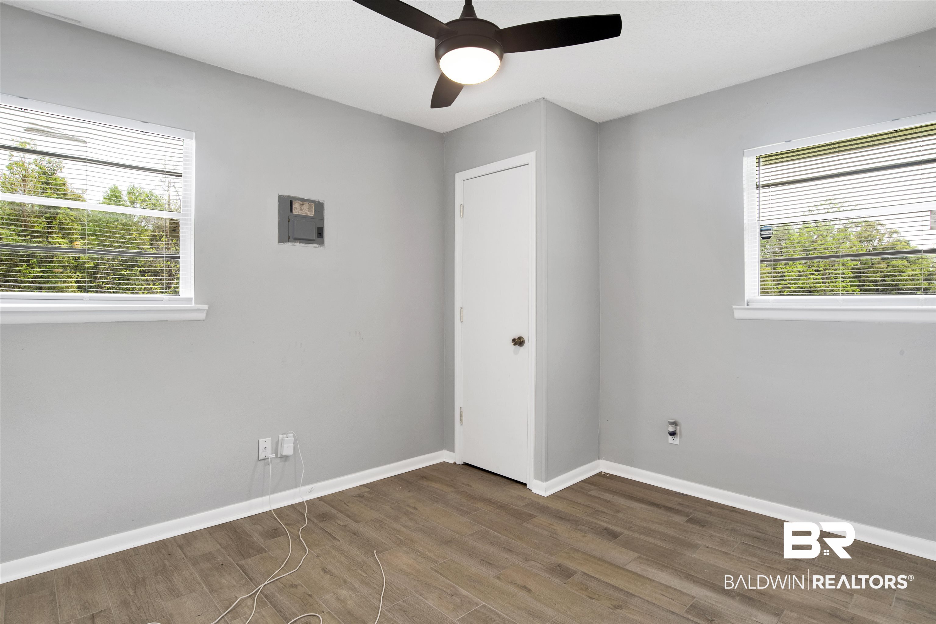 10244 Magnolia Road Irvington, AL 36544 - Photo 14 of 37 Spare room with a ceiling fan, baseboards, a healthy amount of sunlight, and wood finished floors