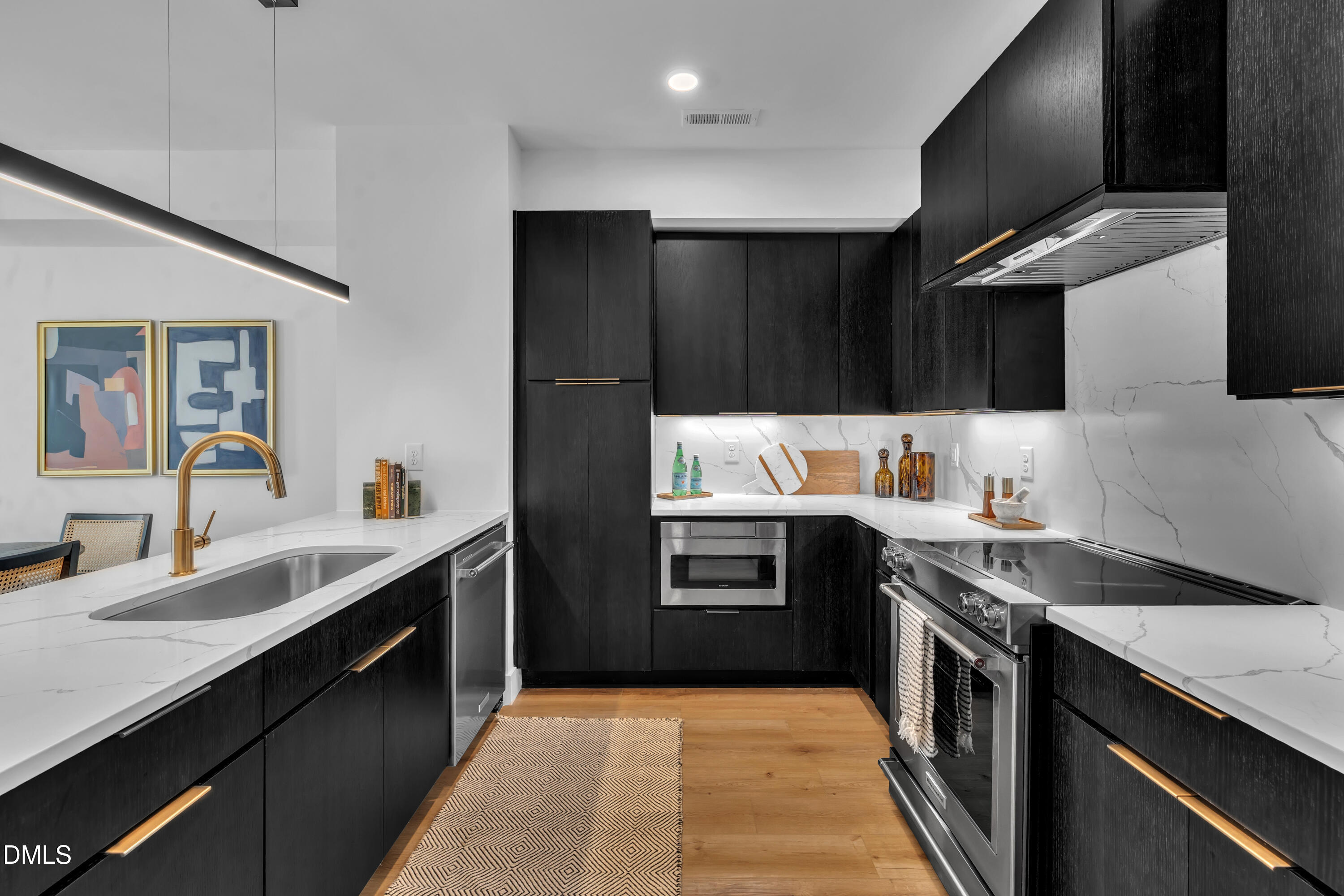 512 Gordon Street, Unit 305 Durham, NC 27701 - Photo 11 of 38 a kitchen with granite countertop a sink stainless steel appliances and cabinets