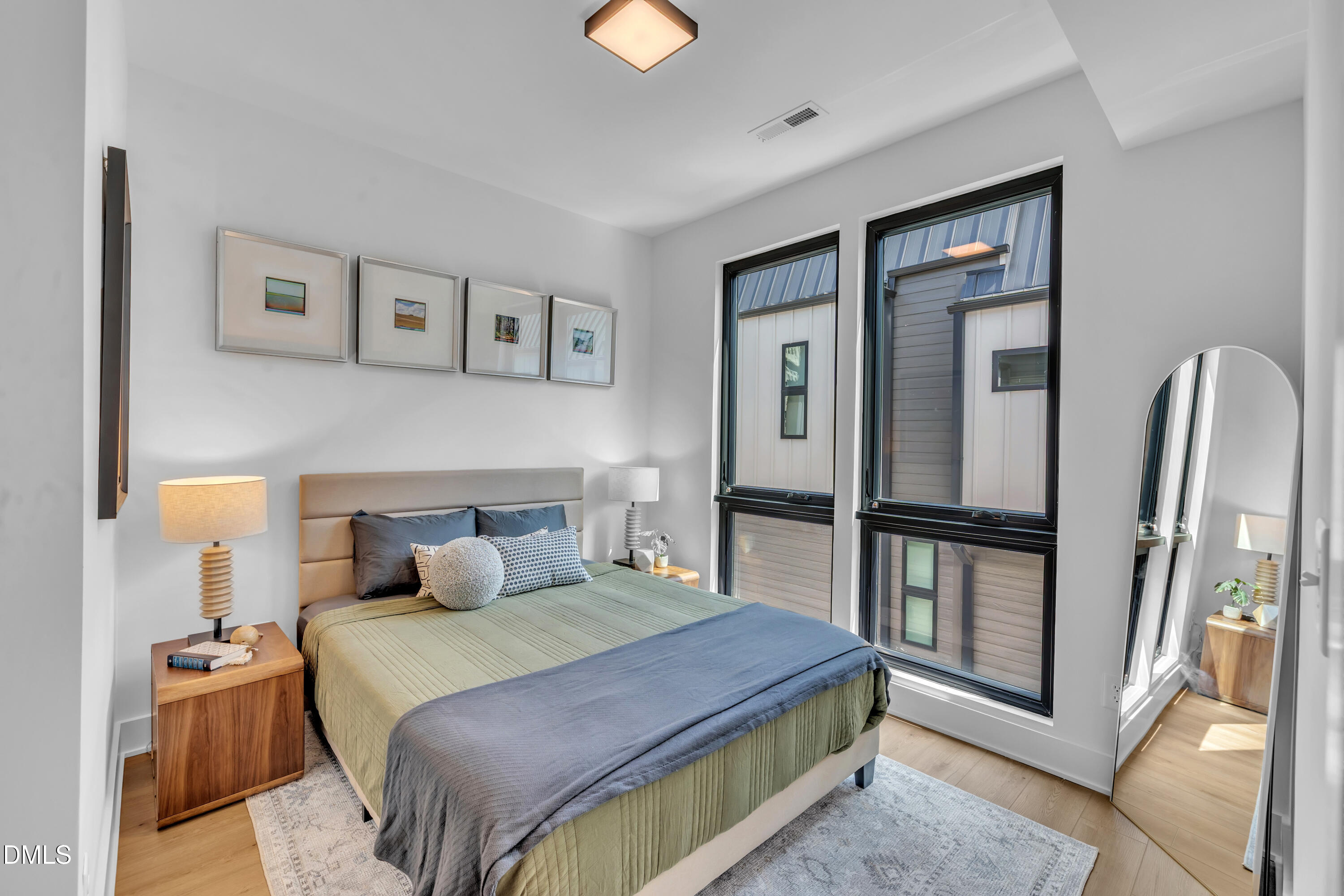 512 Gordon Street, Unit 305 Durham, NC 27701 - Photo 21 of 38 a bedroom with a bed and a painting on the wall