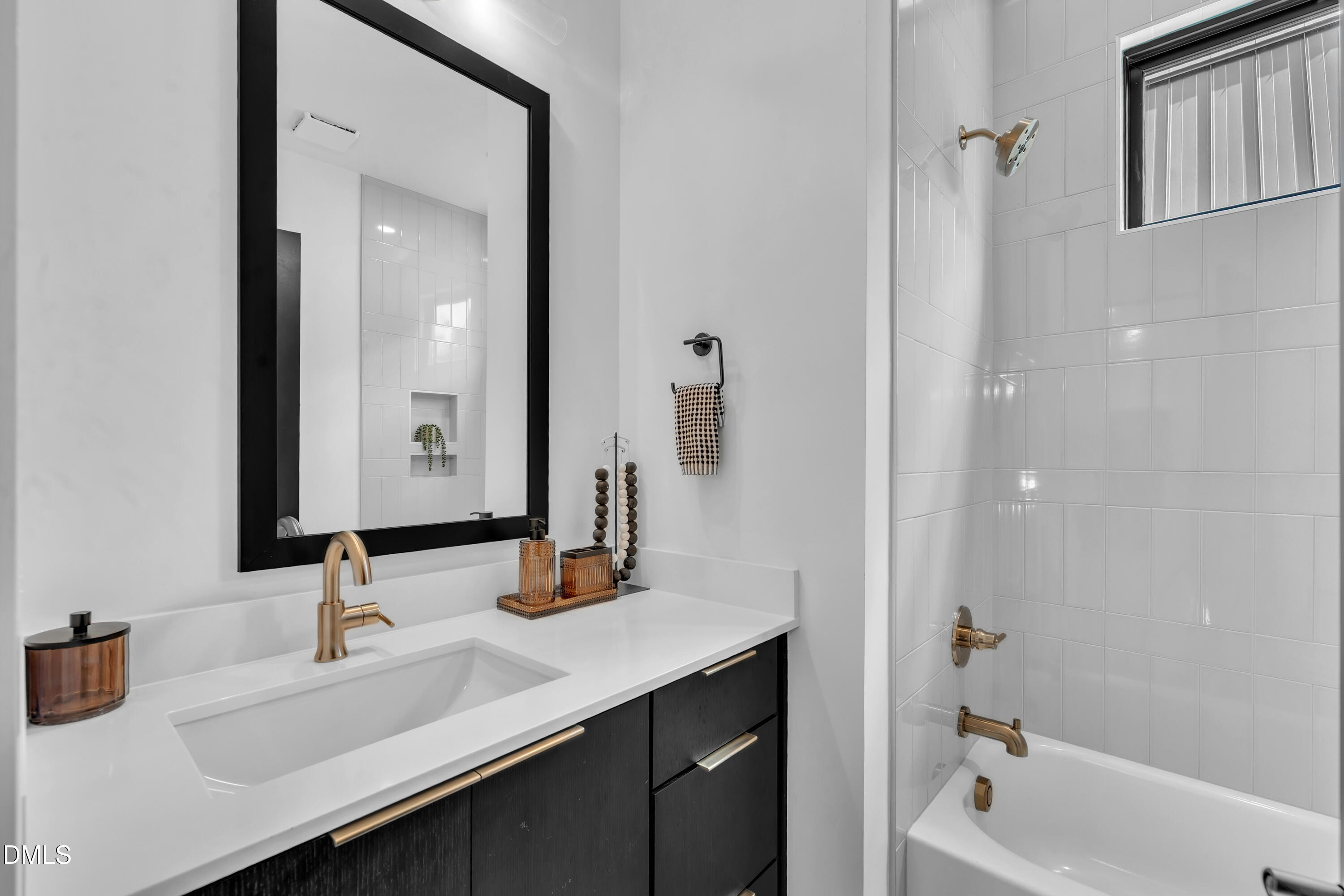 512 Gordon Street, Unit 305 Durham, NC 27701 - Photo 22 of 38 a bathroom with a sink and a mirror
