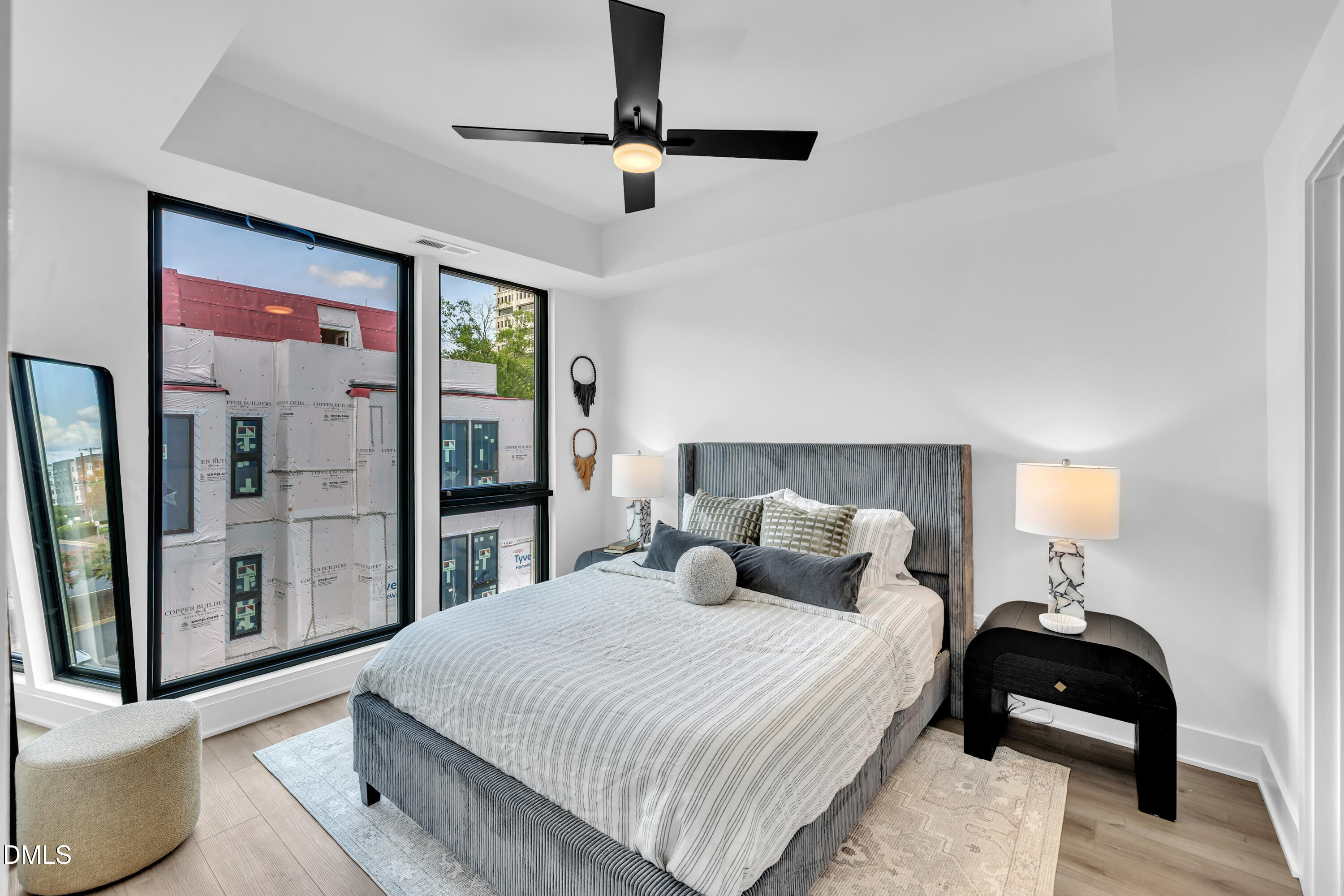 512 Gordon Street, Unit 305 Durham, NC 27701 - Photo 23 of 38 a bedroom with a bed and glass walk in closet