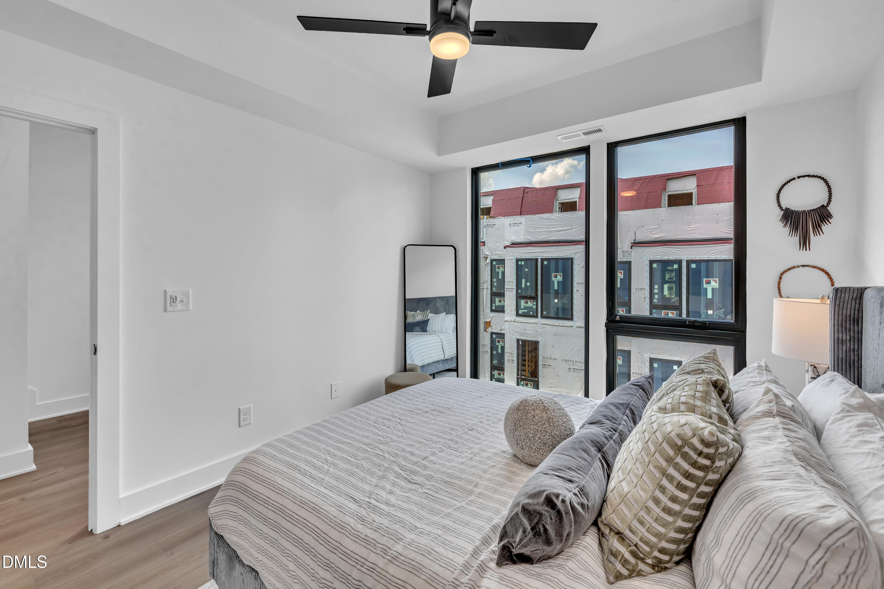 512 Gordon Street, Unit 305 Durham, NC 27701 - Photo 24 of 38 a bedroom with a bed and a large window