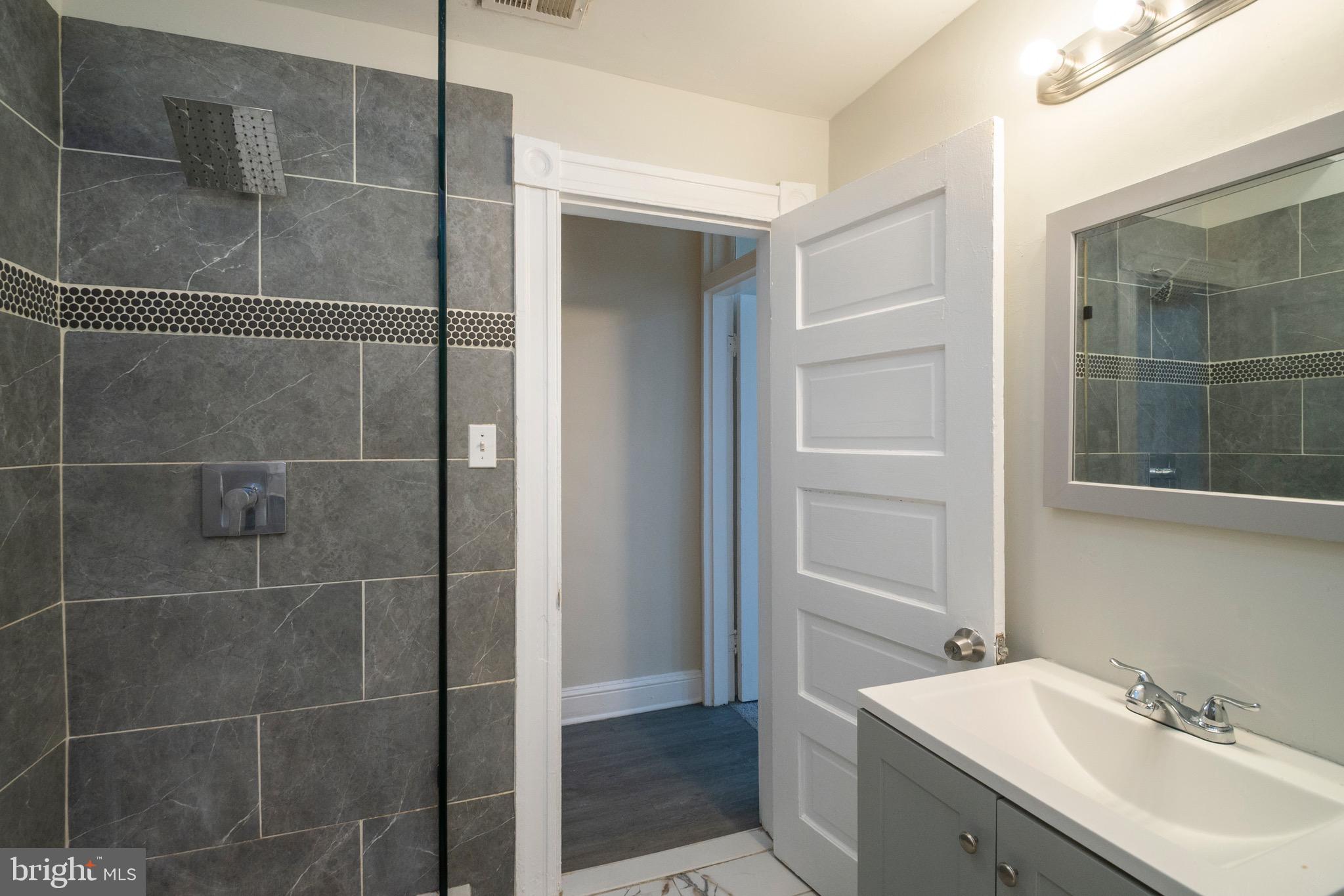 1626 Appleton Street Baltimore, MD 21217 - Photo 14 of 22 a bathroom with a shower and a sink