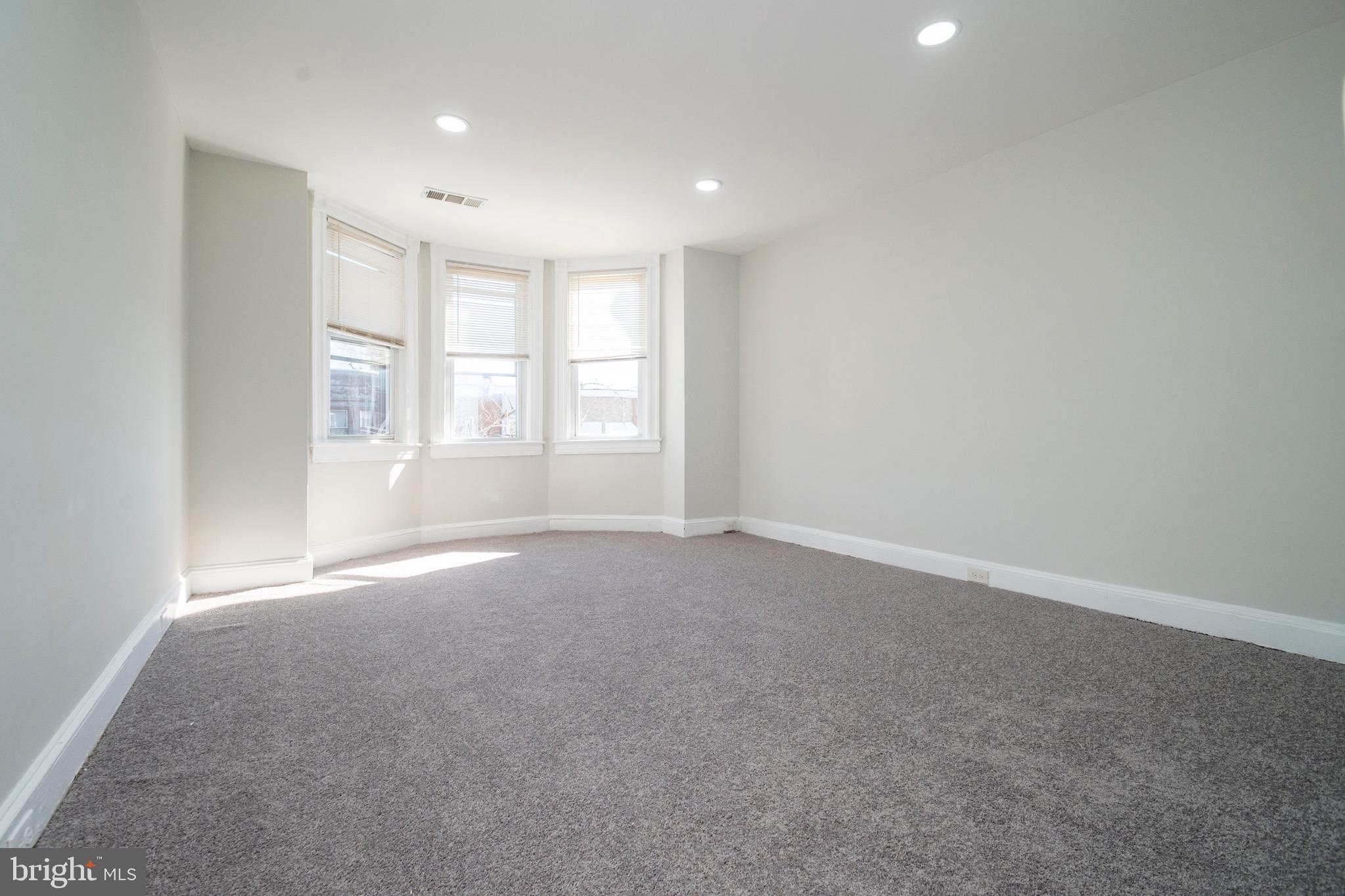 1626 Appleton Street Baltimore, MD 21217 - Photo 19 of 22 an empty room with windows