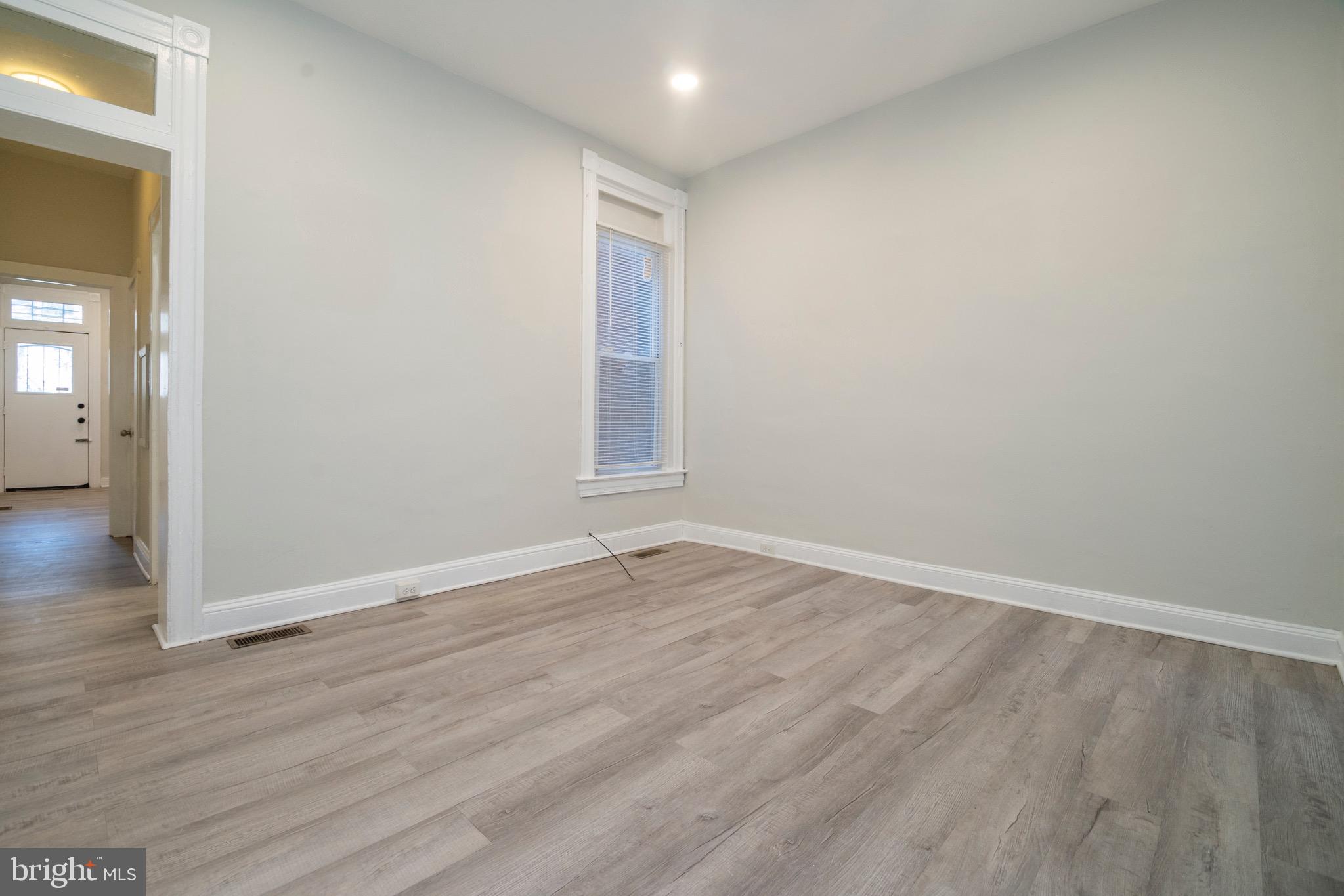 1626 Appleton Street Baltimore, MD 21217 - Photo 5 of 22 a view of an empty room with wooden floor