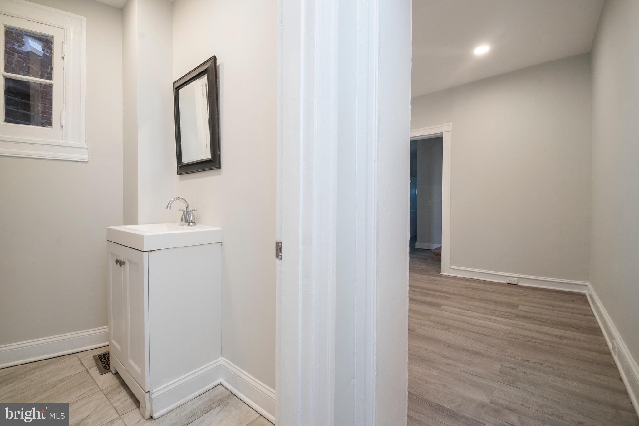 1626 Appleton Street Baltimore, MD 21217 - Photo 7 of 22 a bathroom with a sink and a mirror