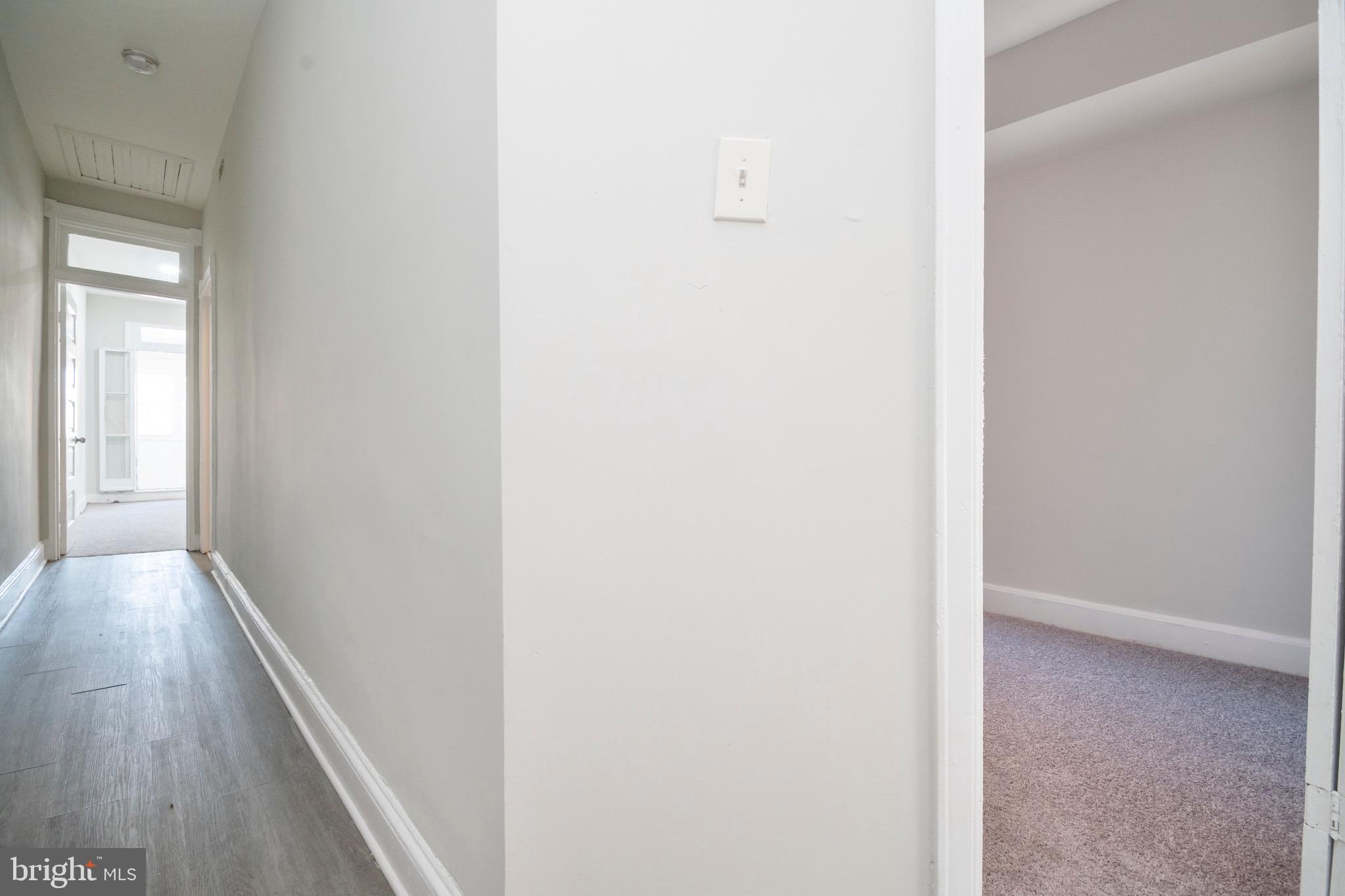 1626 Appleton Street Baltimore, MD 21217 - Photo 10 of 22 a view of a hallway with wooden floor