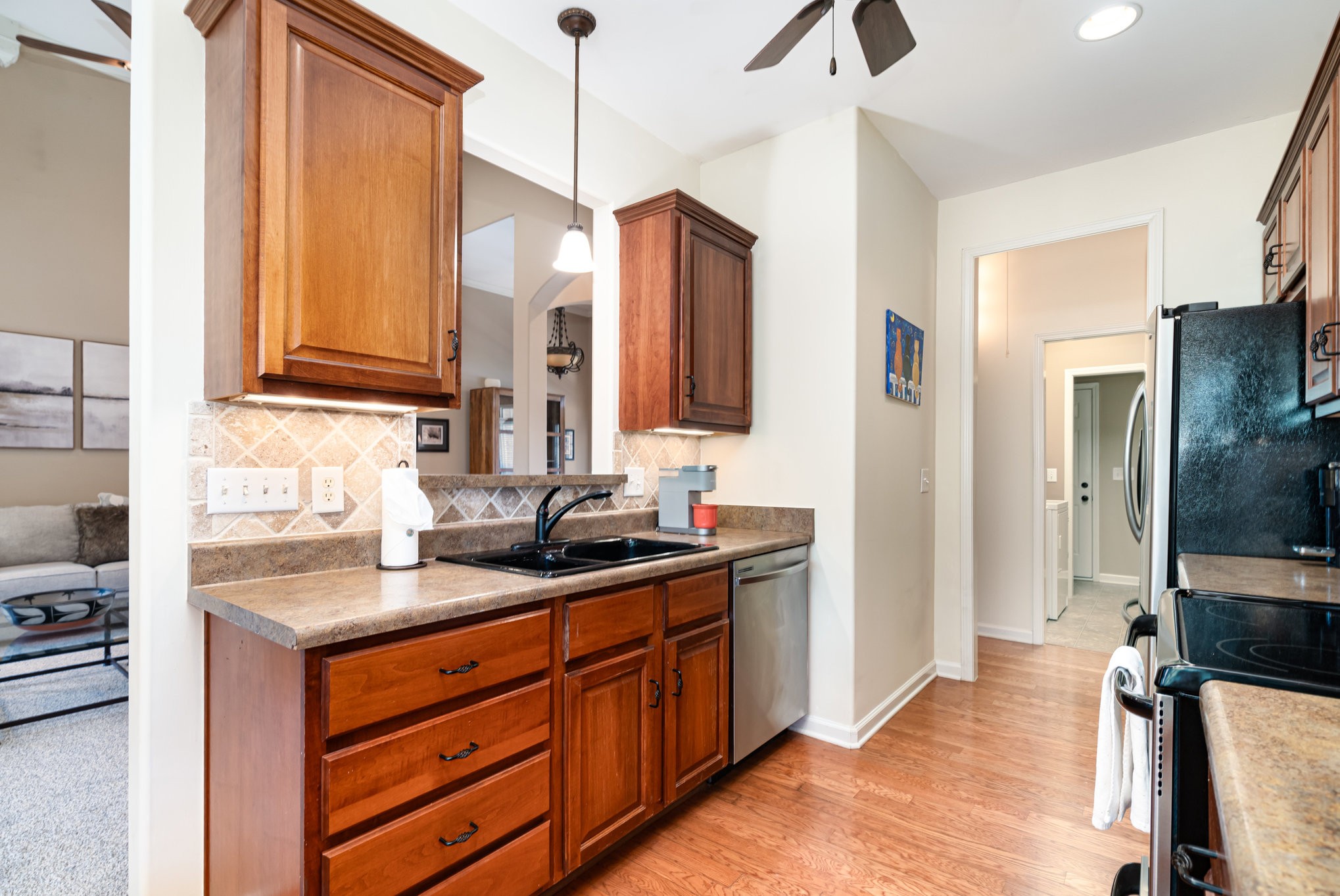 6015 Warner Court Spring Hill, TN 37174 - Photo 12 of 35 a kitchen with stainless steel appliances granite countertop a sink a stove and a refrigerator