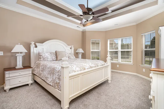 a bedroom with a large bed and a chandelier