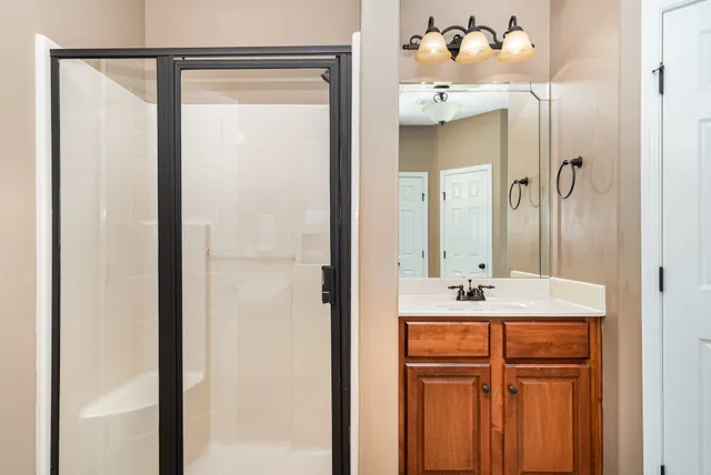 a bathroom with a sink vanity and a mirror