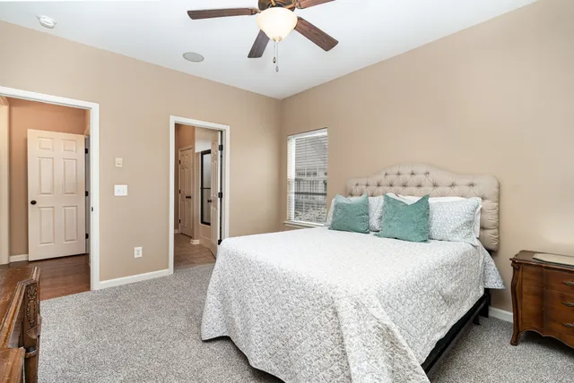 a bedroom with a large bed and a chandelier