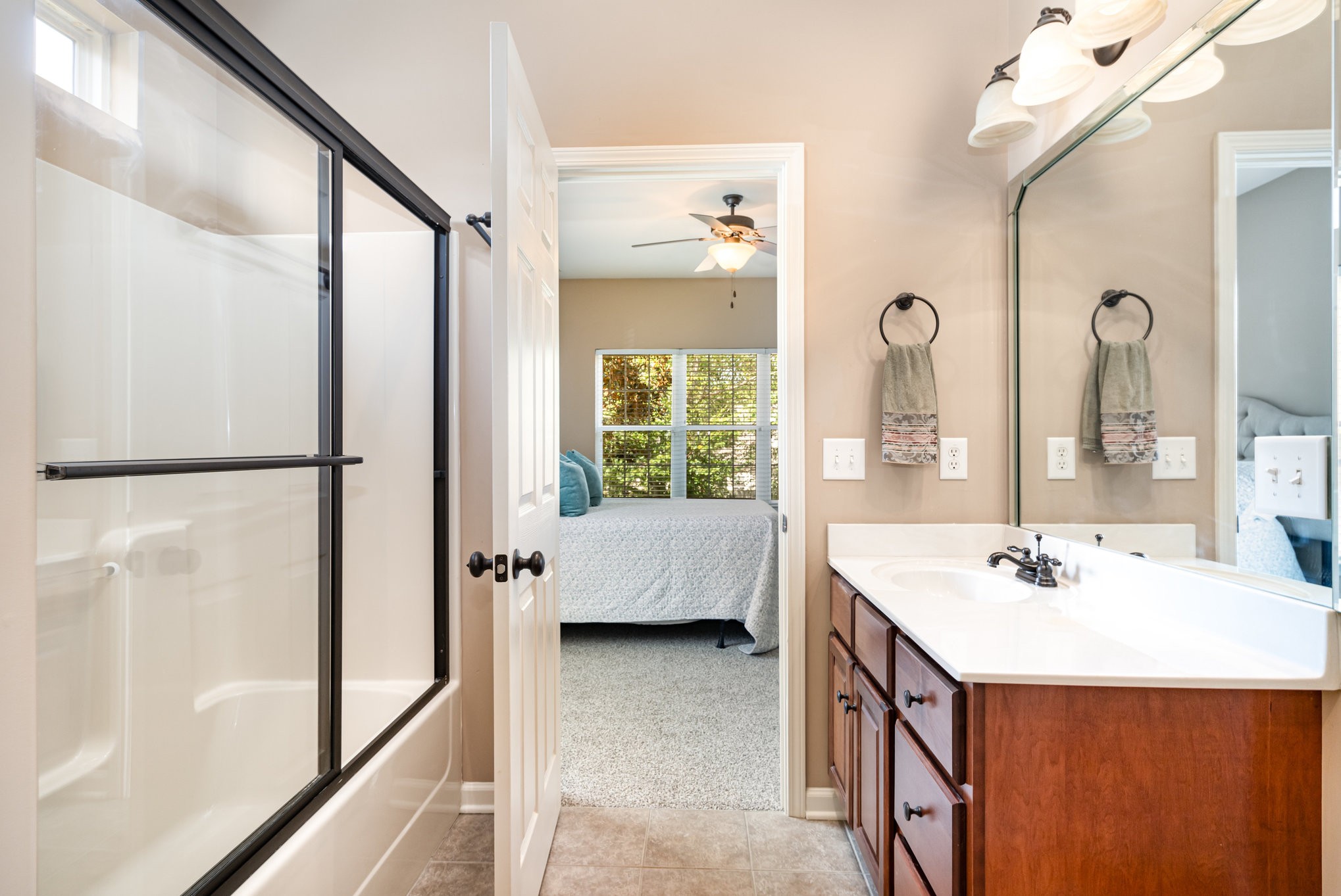 6015 Warner Court Spring Hill, TN 37174 - Photo 23 of 35 a en suite bathroom with a double vanity sink a mirror and a bathtub