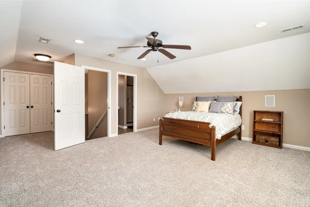 a bedroom with furniture and a ceiling fan