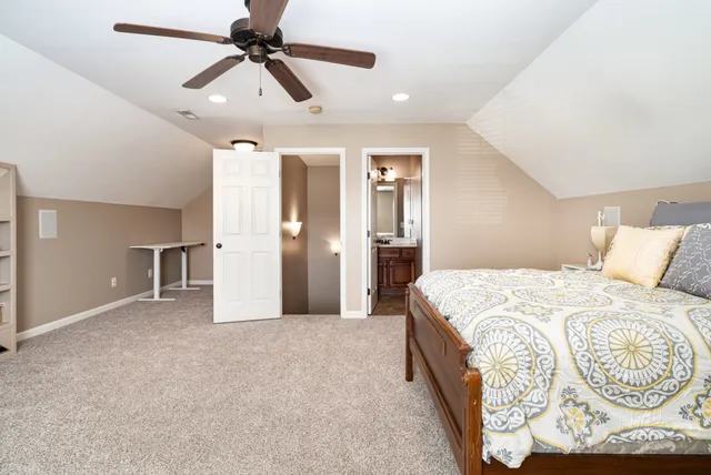 a spacious bedroom with a bed and a chandelier