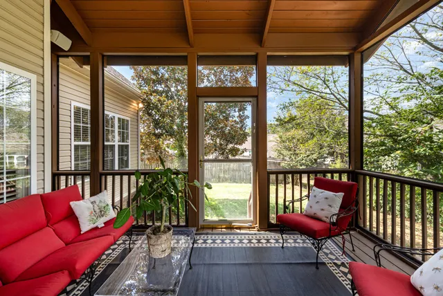 a balcony with furniture and a potted plant