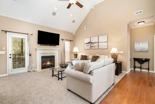 a living room with furniture a fireplace and a flat screen tv