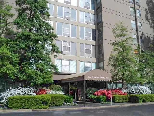 a front view of a building with umbrellas
