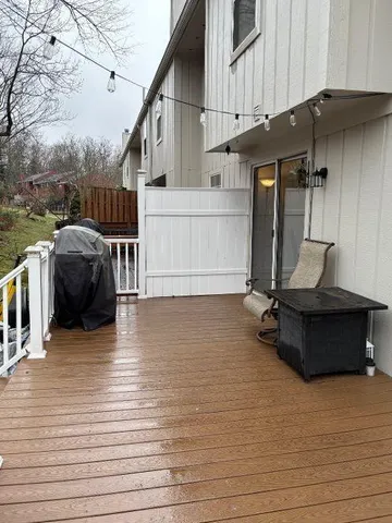 a living room with couches and pool table with wooden floor