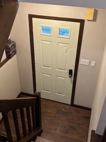 a view of a hallway with wooden floor