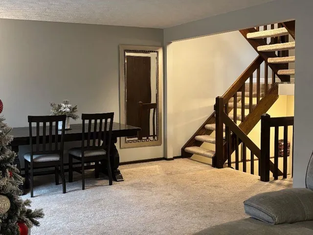 a view of living room with furniture and staircase