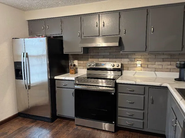a kitchen with a stove sink and refrigerator