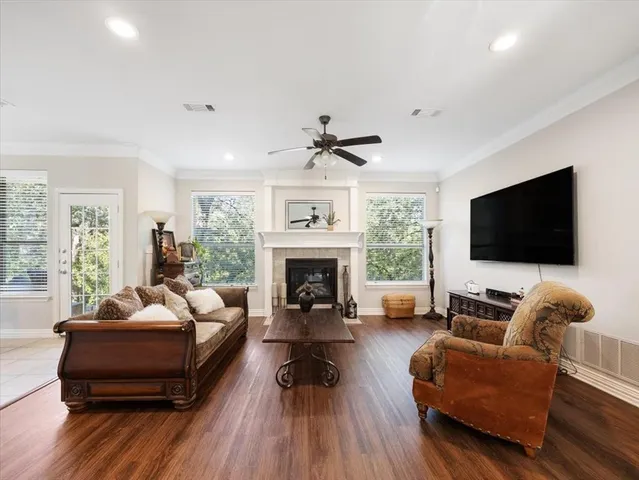 a living room with furniture a fireplace and a flat screen tv
