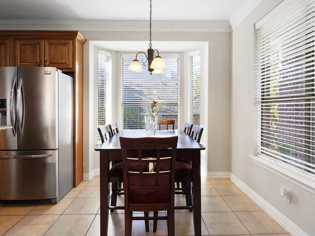a living room with furniture flat screen tv and a large window