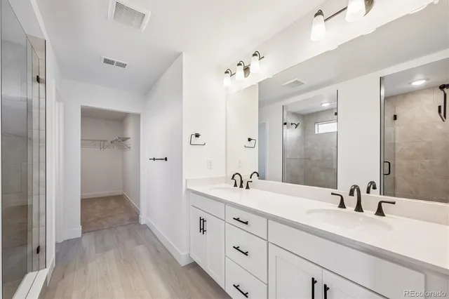 a bathroom with a double vanity sink and mirror