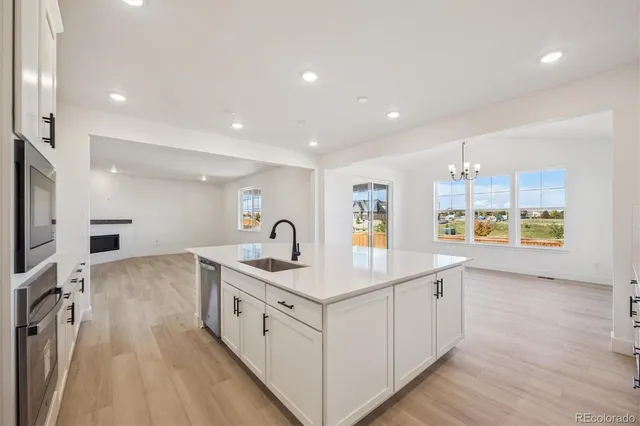 a kitchen with a sink stove and cabinets