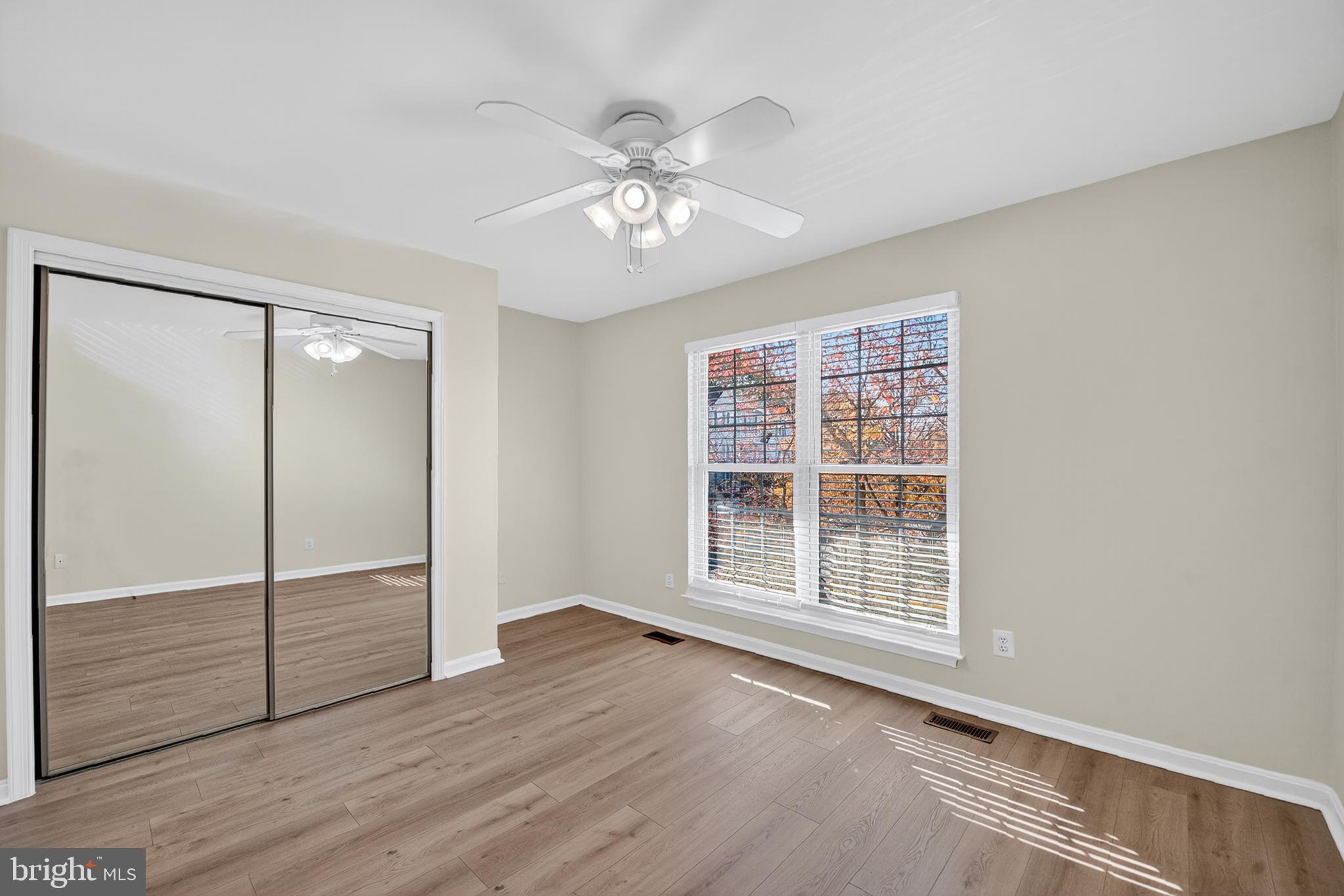 46932 Courtyard Square Sterling, VA 20164 - Photo 11 of 15 a view of an empty room with wooden floor and a window