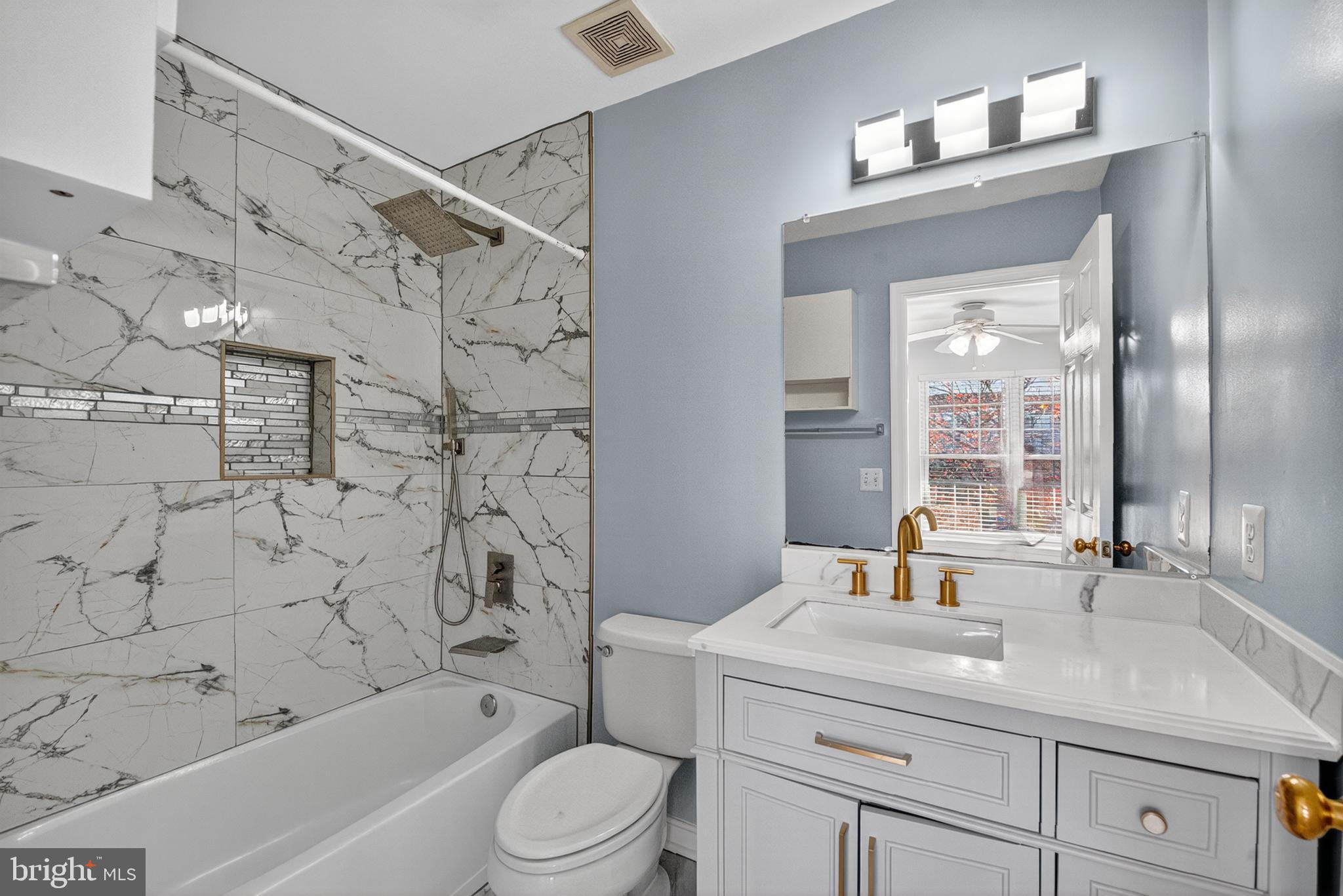 46932 Courtyard Square Sterling, VA 20164 - Photo 12 of 15 a bathroom with a sink a toilet and shower