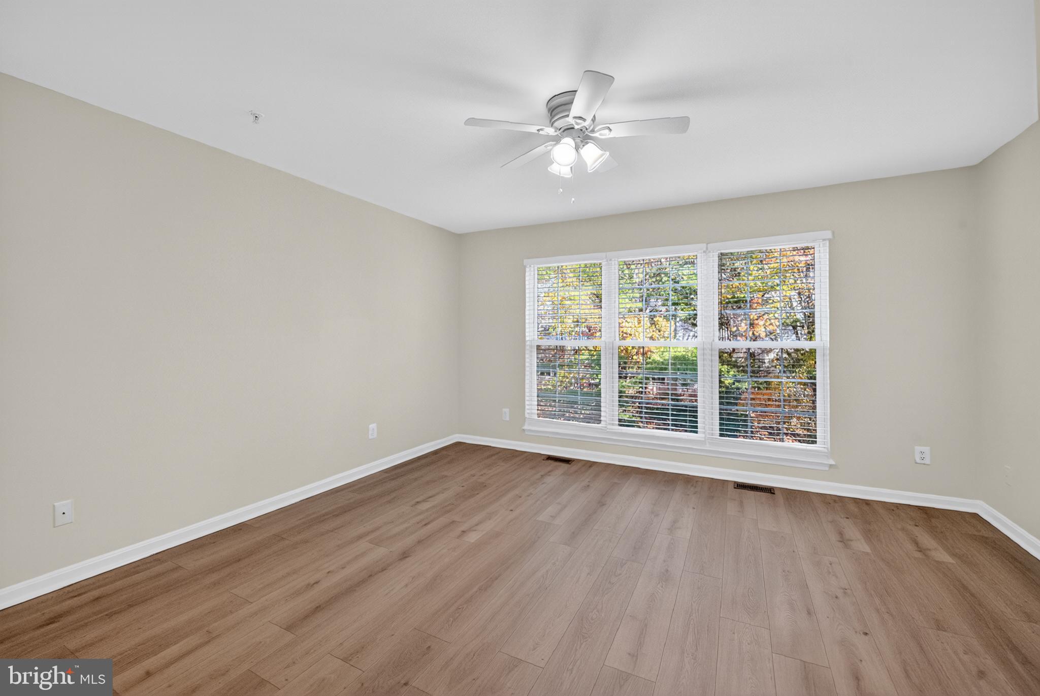 46932 Courtyard Square Sterling, VA 20164 - Photo 9 of 15 a view of an empty room with wooden floor and a window