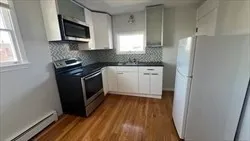a kitchen with stainless steel appliances granite countertop a stove a microwave a sink and a refrigerator