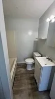 a bathroom with a sink a toilet and a mirror