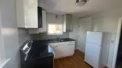 a kitchen with a refrigerator and a sink