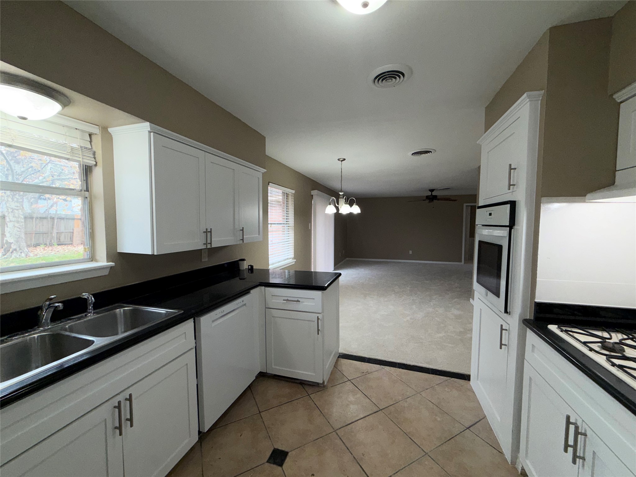 7306 Troulon Drive Houston, TX 77074 - Photo 8 of 16 a kitchen with granite countertop a sink and a stove top oven