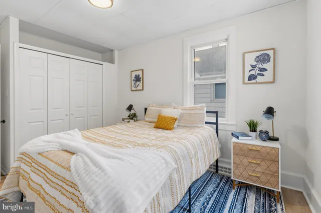 a bedroom with bed and wooden floor