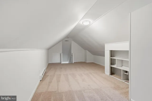 a view of an empty room with a kitchen