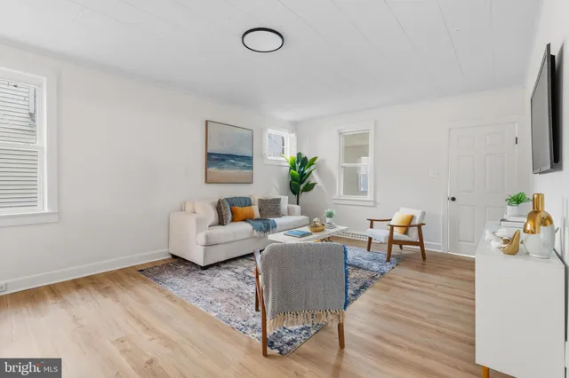 a living room with fireplace furniture and a wooden floor