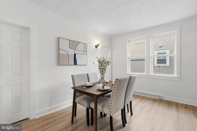 a dining room with furniture and wooden floor
