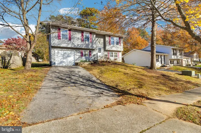 a view of a house with snow on the side of the road