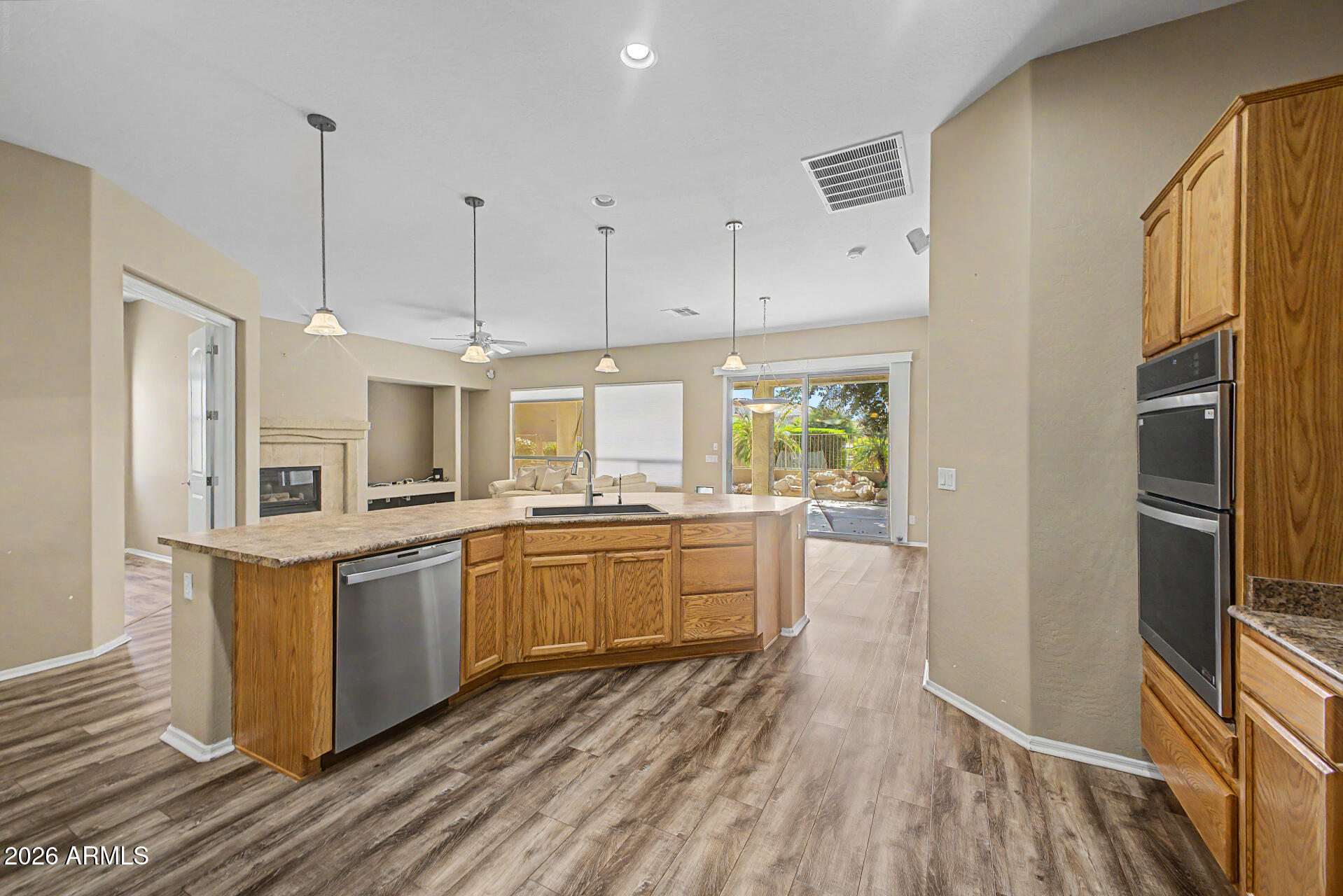 5090 South Ranger Trail Gilbert, AZ 85298 - Photo 12 of 50 a kitchen with stainless steel appliances granite countertop a refrigerator a stove a sink and white cabinets