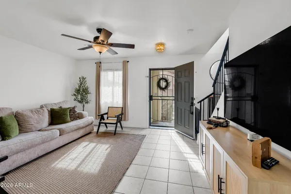 a living room with furniture and a ceiling fan