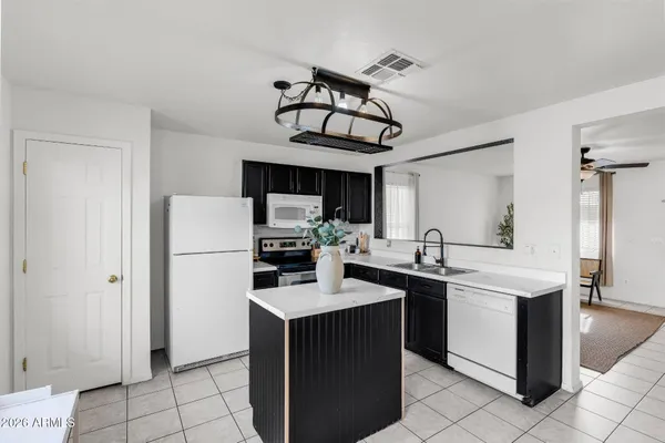 a kitchen with a sink a stove top oven and cabinets