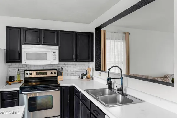 a kitchen with a sink stove and microwave