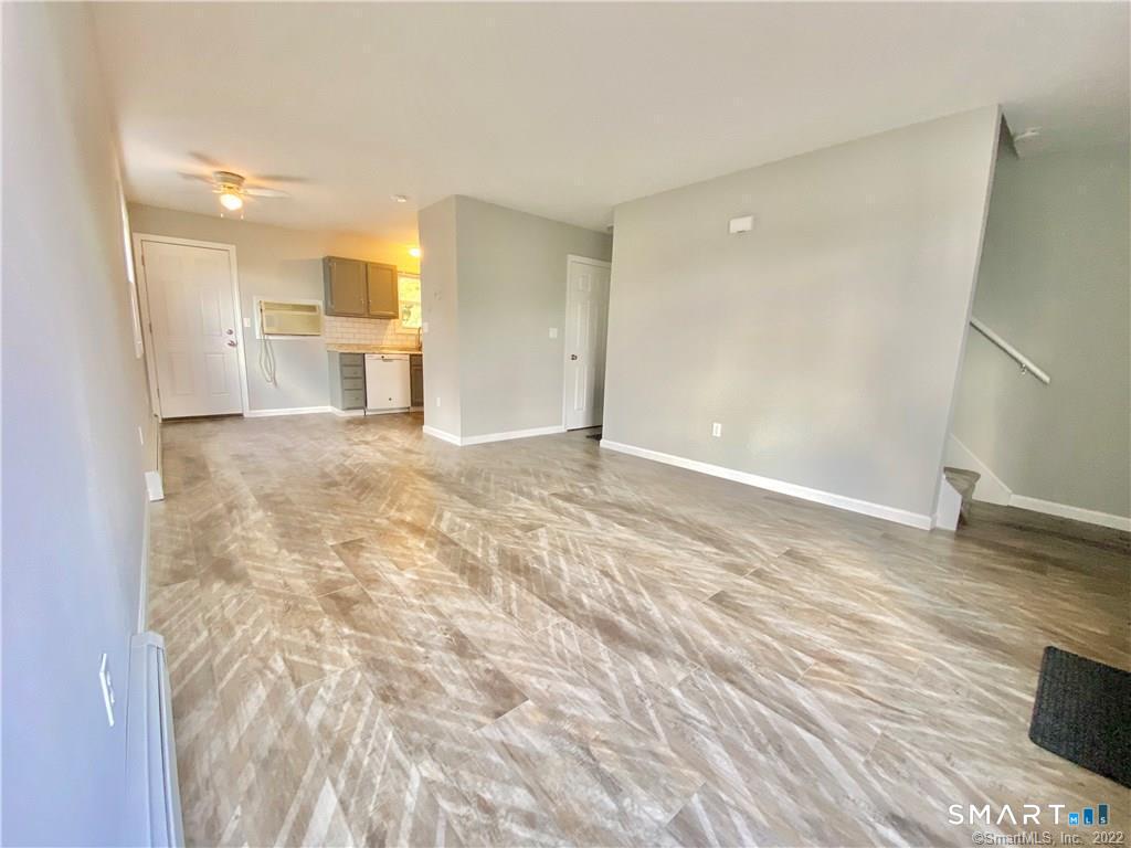 35 Ojibwa Road, Unit A Shelton, CT 06484 - Photo 2 of 8 a view of a kitchen with wooden floor and a refrigerator