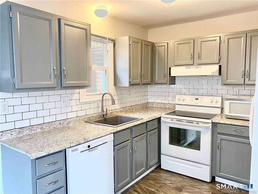 35 Ojibwa Road, Unit A Shelton, CT 06484 - Photo 3 of 8 a kitchen with a sink stove and cabinets