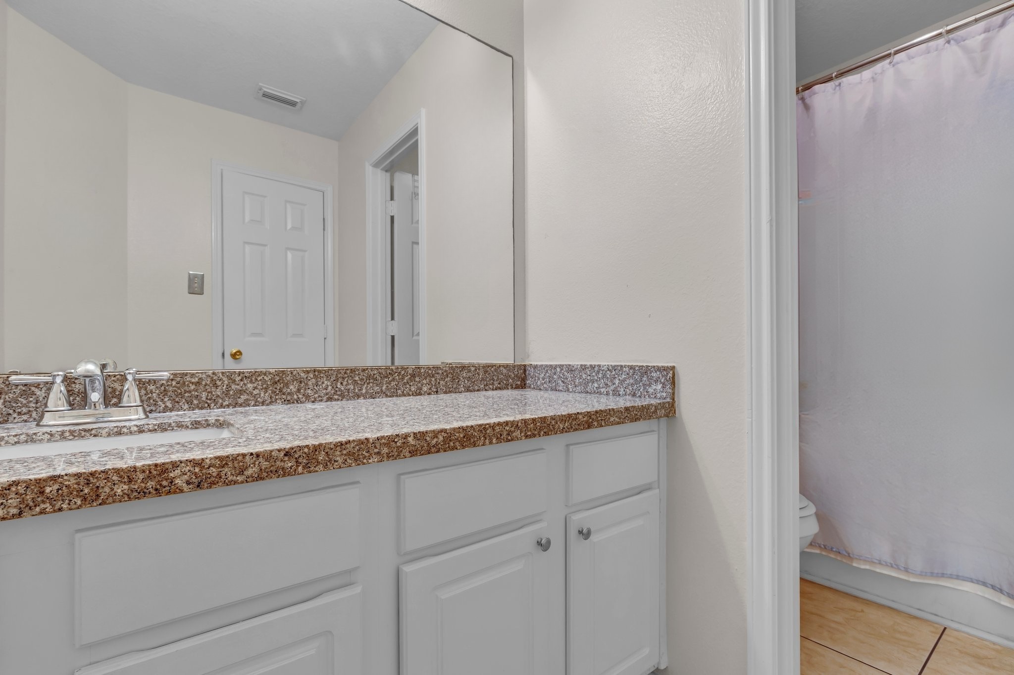 1130 Fairlane Square Channelview, TX 77530 - Photo 13 of 22 a bathroom with a granite countertop sink and a mirror
